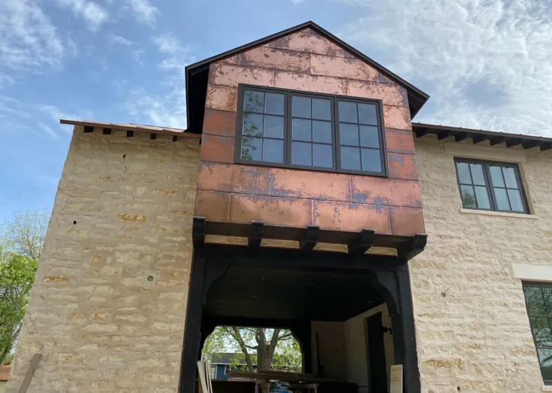 Copper metal panel facade on a stone building for Roof Repair in Pike Creek Valley