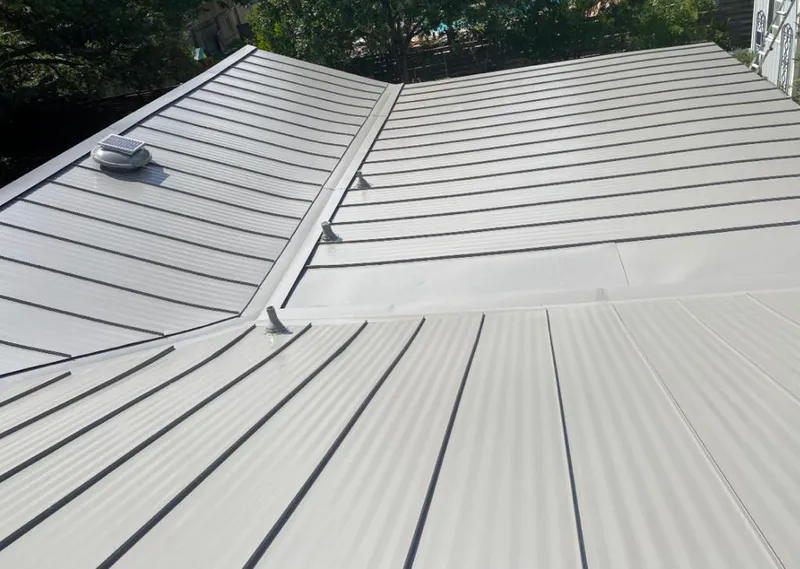 Solar attic fan installed on a metal roof for Roof Ventilation in Pike Creek Valley